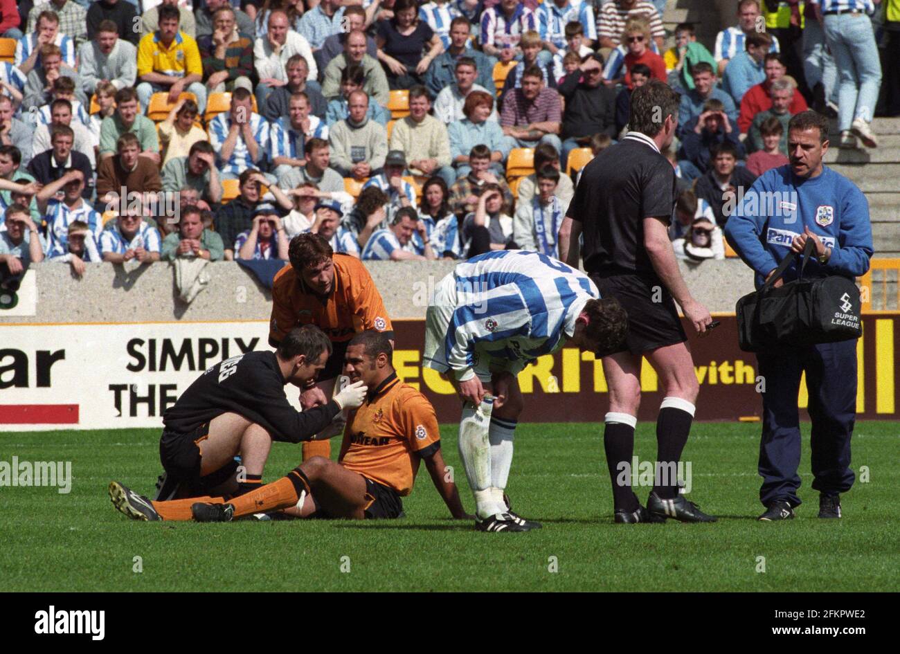 Footballer Don Goodman is checked out by Barry Holmes after a clash of heads. Goodman had suffered a depressed skull fracture. Wolverhampton Wanderers v Huddersfield Town 27/4/96 head injury football Stock Photo