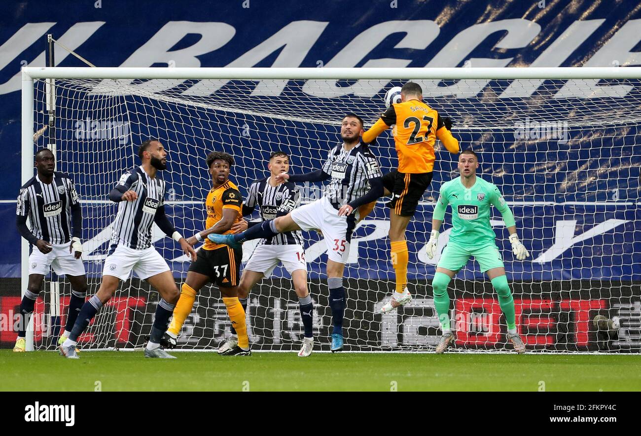 Wolverhampton Wanderers' Romain Saiss (27) heads straight at West Bromwich Albion goalkeeper Sam Johnstone during the Premier League match at The Hawthorns, West Bromwich. Issue date: Monday May 3, 2021. Stock Photo