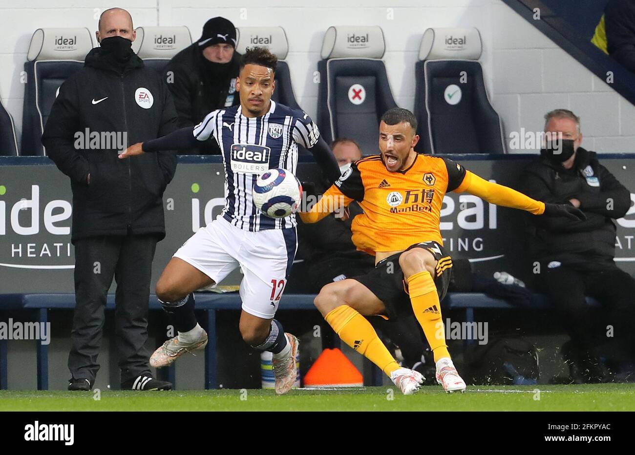 West Bromwich Albion's Matheus Pereira (left) and Wolverhampton Wanderers' Romain Saiss battle for the ball during the Premier League match at The Hawthorns, West Bromwich. Issue date: Monday May 3, 2021. Stock Photo