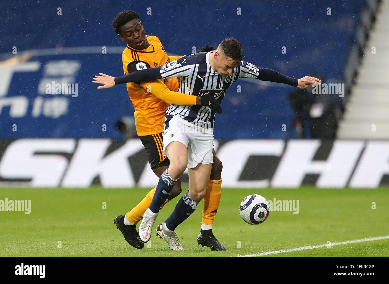 Wolverhampton Wanderers' Owen Otasowie (left) and West Bromwich Albion's Conor Townsend battle for the ball during the Premier League match at The Hawthorns, West Bromwich. Issue date: Monday May 3, 2021. Stock Photo