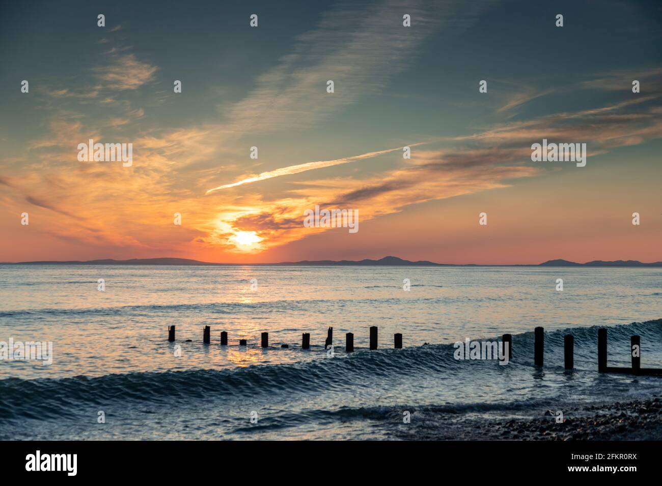Sunset over the Llyn Peninsula from Barmouth, welsh coast Stock Photo