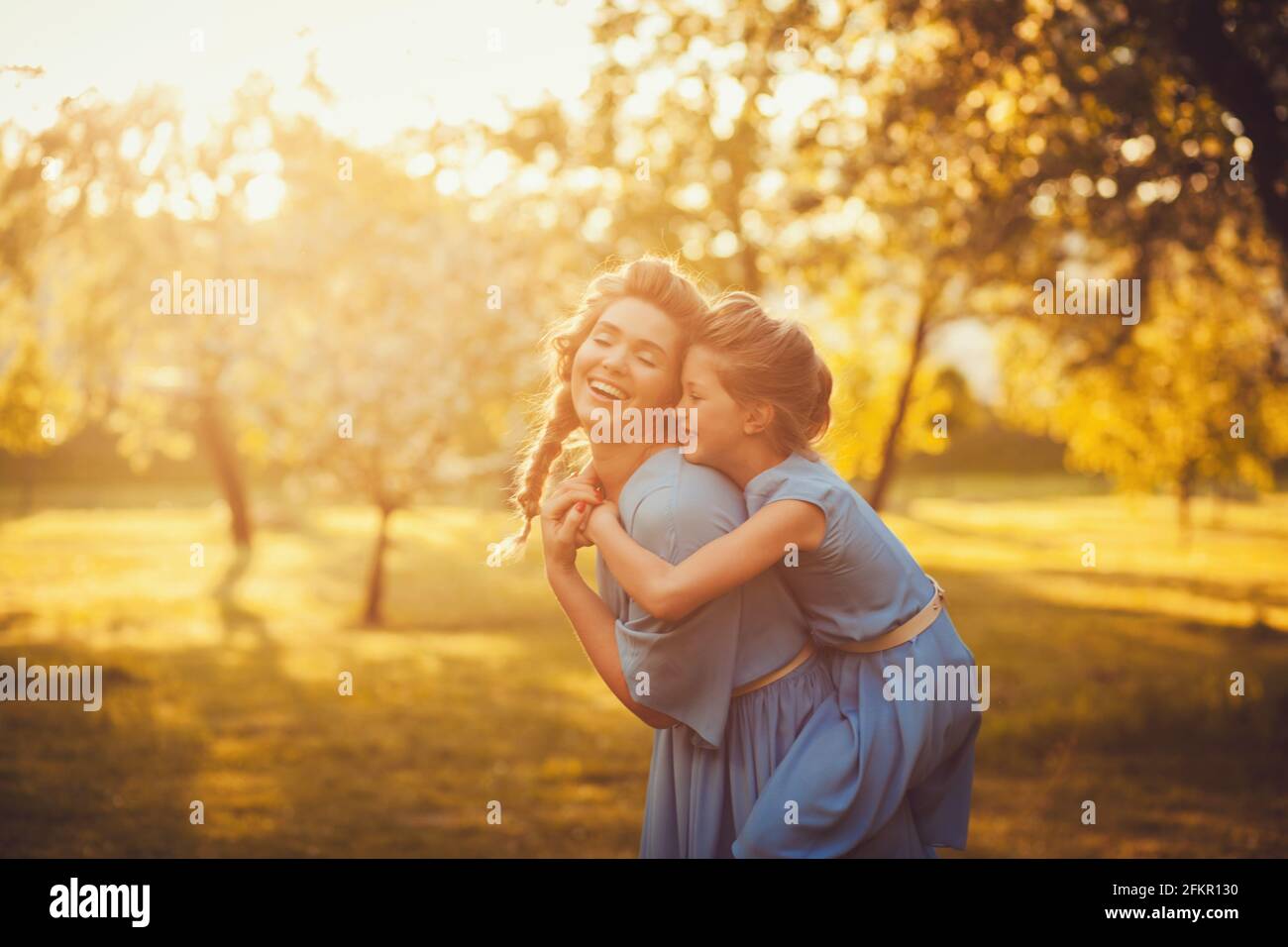 Mother and daughter playing together in a park Stock Photo