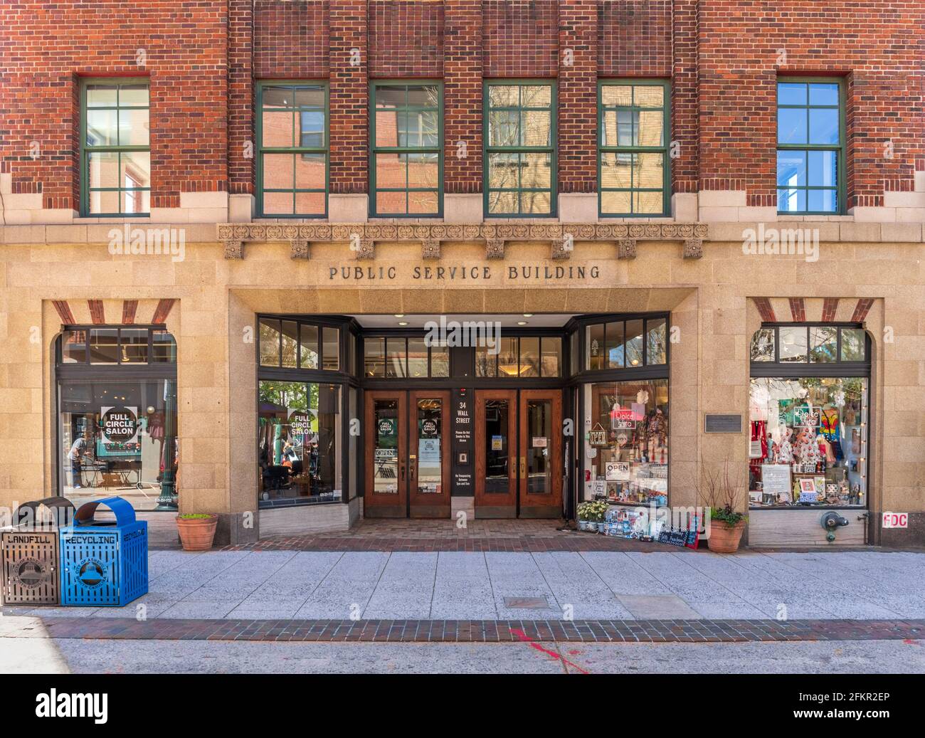 ASHEVILLE, NC, USA-1 MAY 2021: First floor facade of the  historic Public Service Building on Wall Street, with specialty shops.  No people. Stock Photo