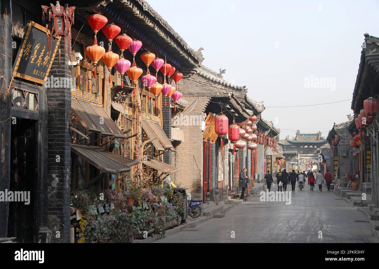 Pingyao in Shanxi Province, China: A road in Pingyao with cafes, restaurants, shops and stores Stock Photo