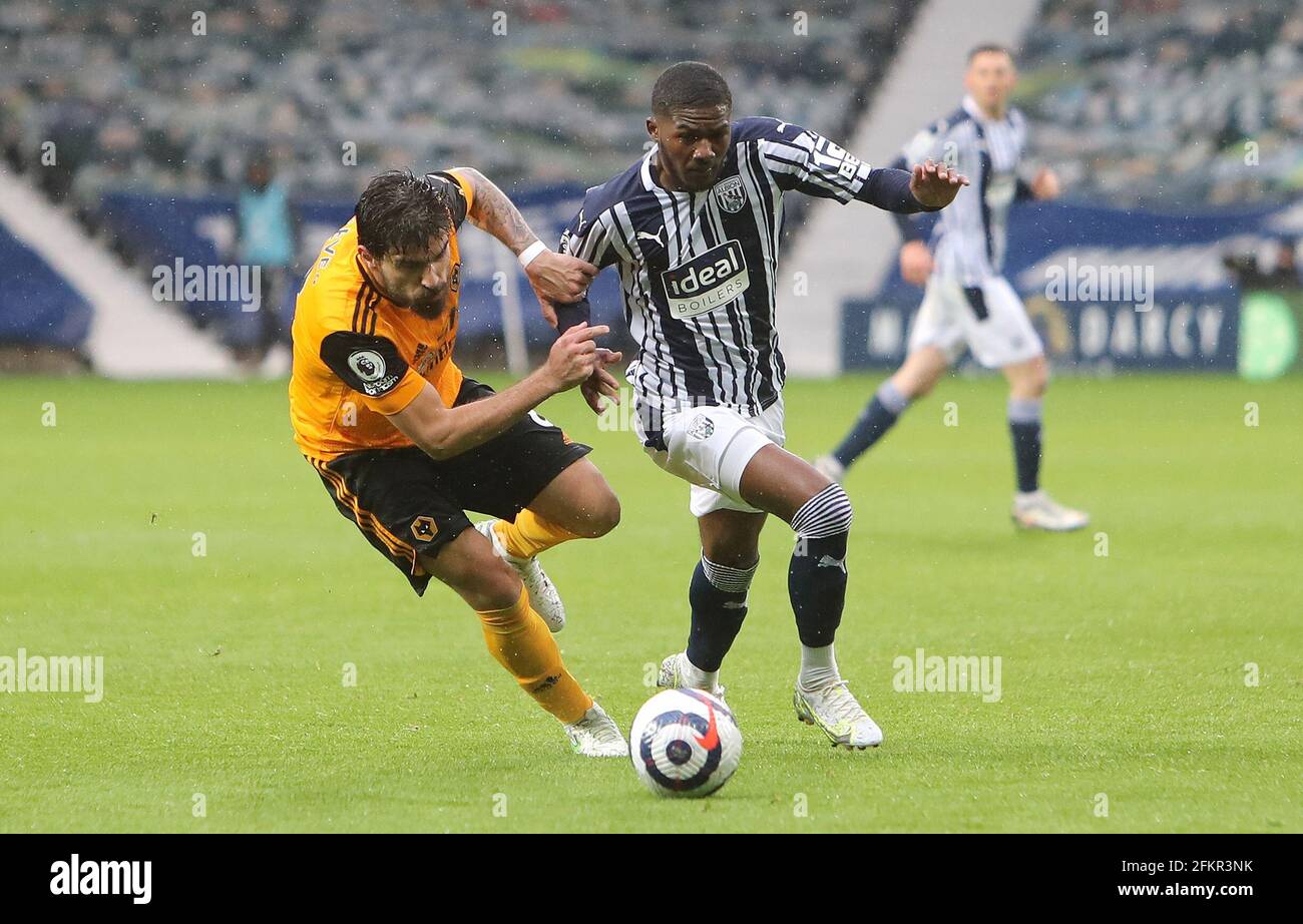 Wolverhampton Wanderers' Ruben Neves (left) and West Bromwich Albion's Ainsley Maitland-Niles battle for the ball during the Premier League match at The Hawthorns, West Bromwich. Issue date: Monday May 3, 2021. Stock Photo