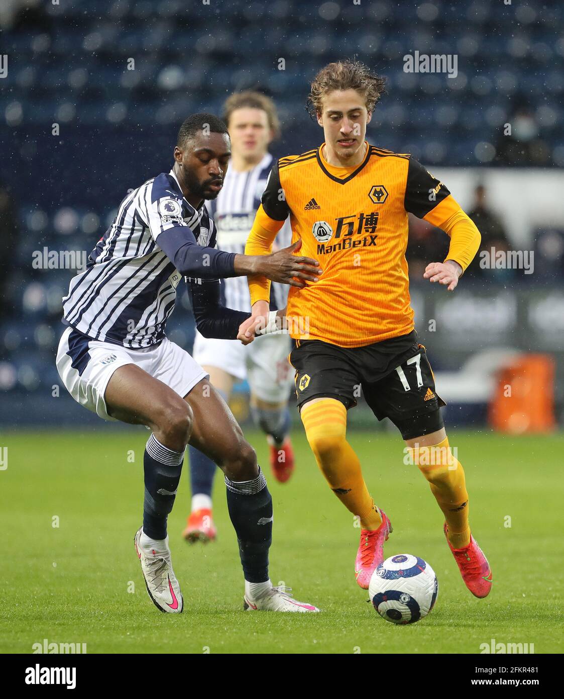 West Bromwich Albion's Semi Ajayi (left) and Wolverhampton Wanderers' Fabio Silva battle for the ball during the Premier League match at The Hawthorns, West Bromwich. Issue date: Monday May 3, 2021. Stock Photo