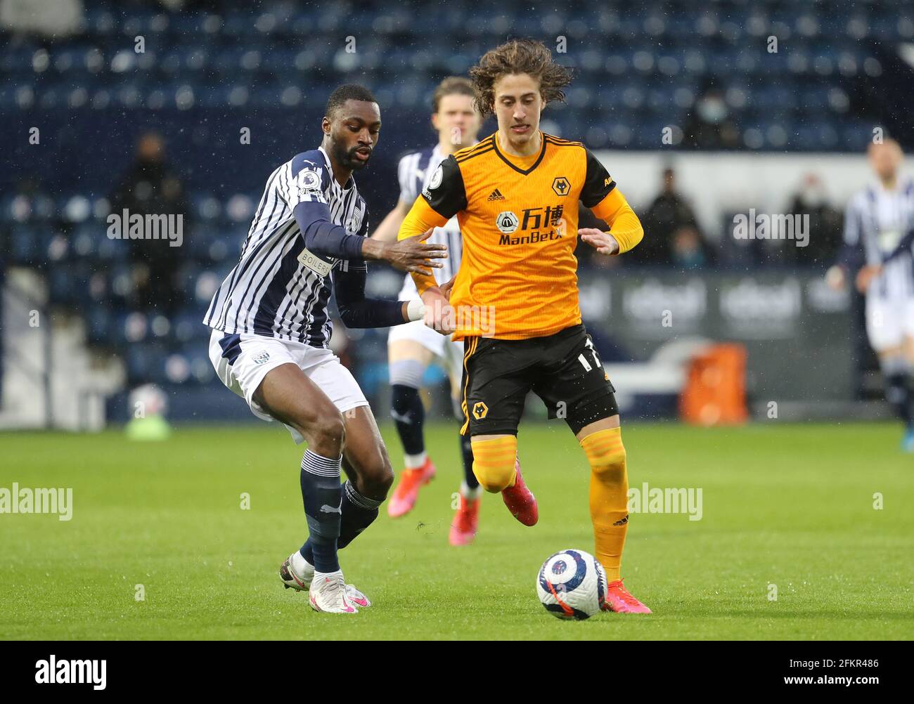 West Bromwich Albion's Semi Ajayi (left) and Wolverhampton Wanderers' Fabio Silva battle for the ball during the Premier League match at The Hawthorns, West Bromwich. Issue date: Monday May 3, 2021. Stock Photo