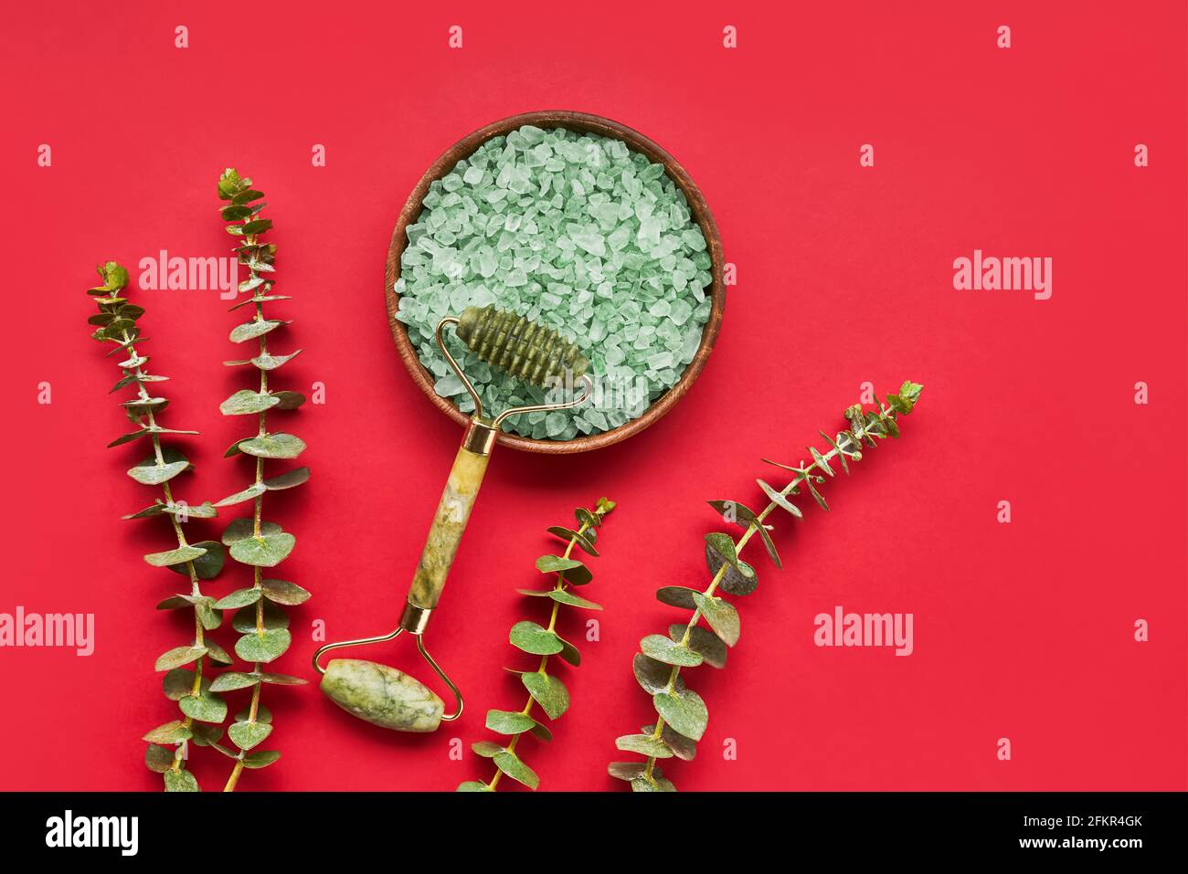 Green face roller from natural jade stone, bath salt, and eucalyptus