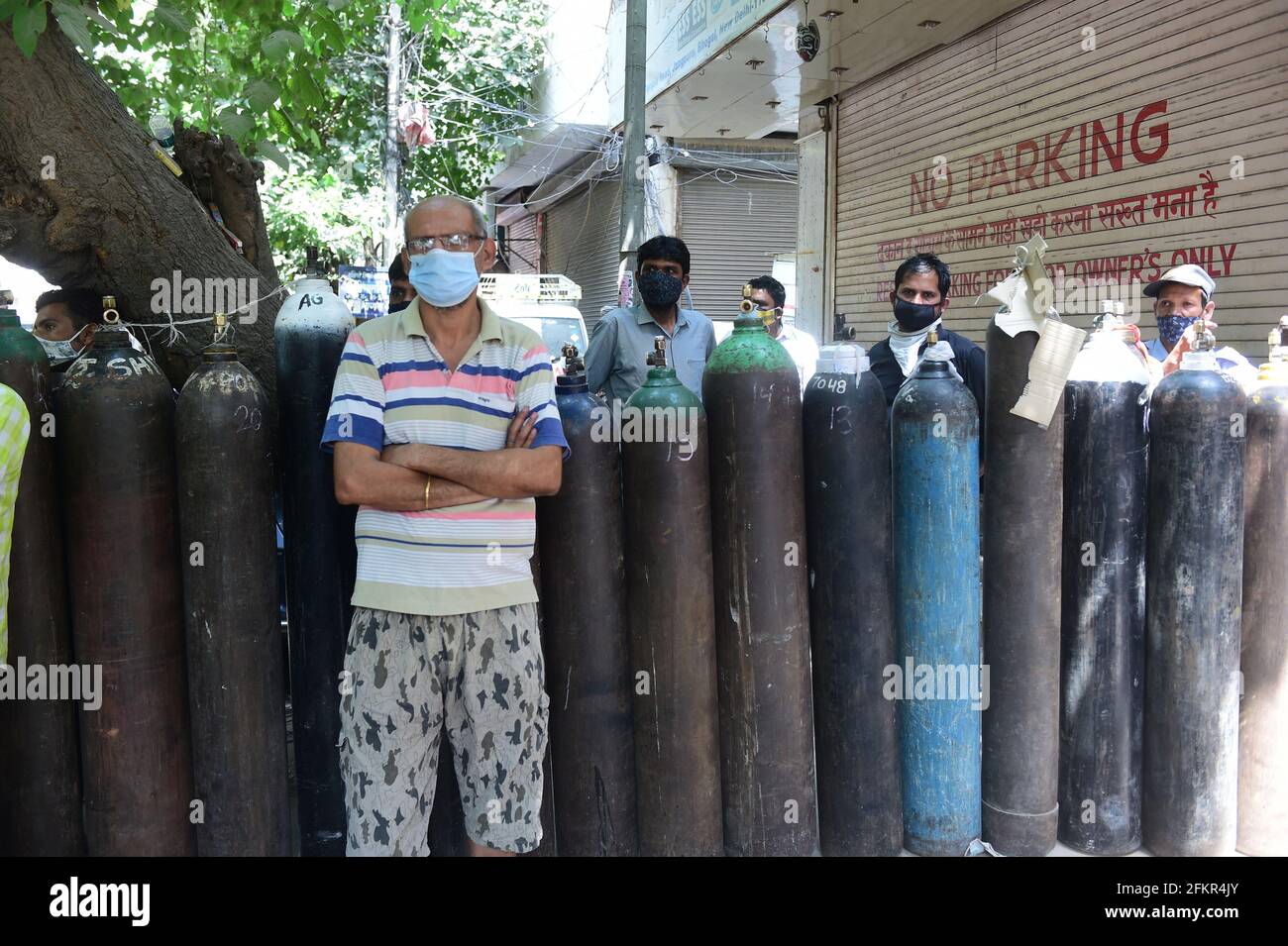 New Delhi, India. 03rd May, 2021. Family members of COVID-19 patients wait outside an oxygen-filling center to refill their empty cylinders, as demand for the gas rises due to spike in coronavirus cases, in New Delhi, India on Monday, May, 3, 2021. Photo by Abhishek/UPI Credit: UPI/Alamy Live News Stock Photo