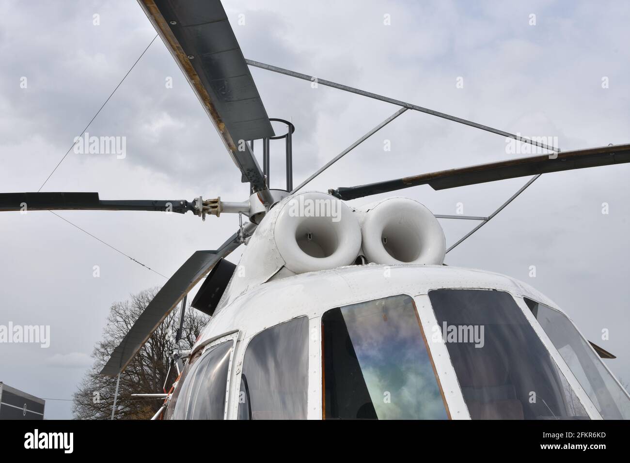 Close up front view on main rotor blades, rotor mast and part of cockpit windows of the Russian white twin-engine multipurpose helicopter Mi-8. Stock Photo