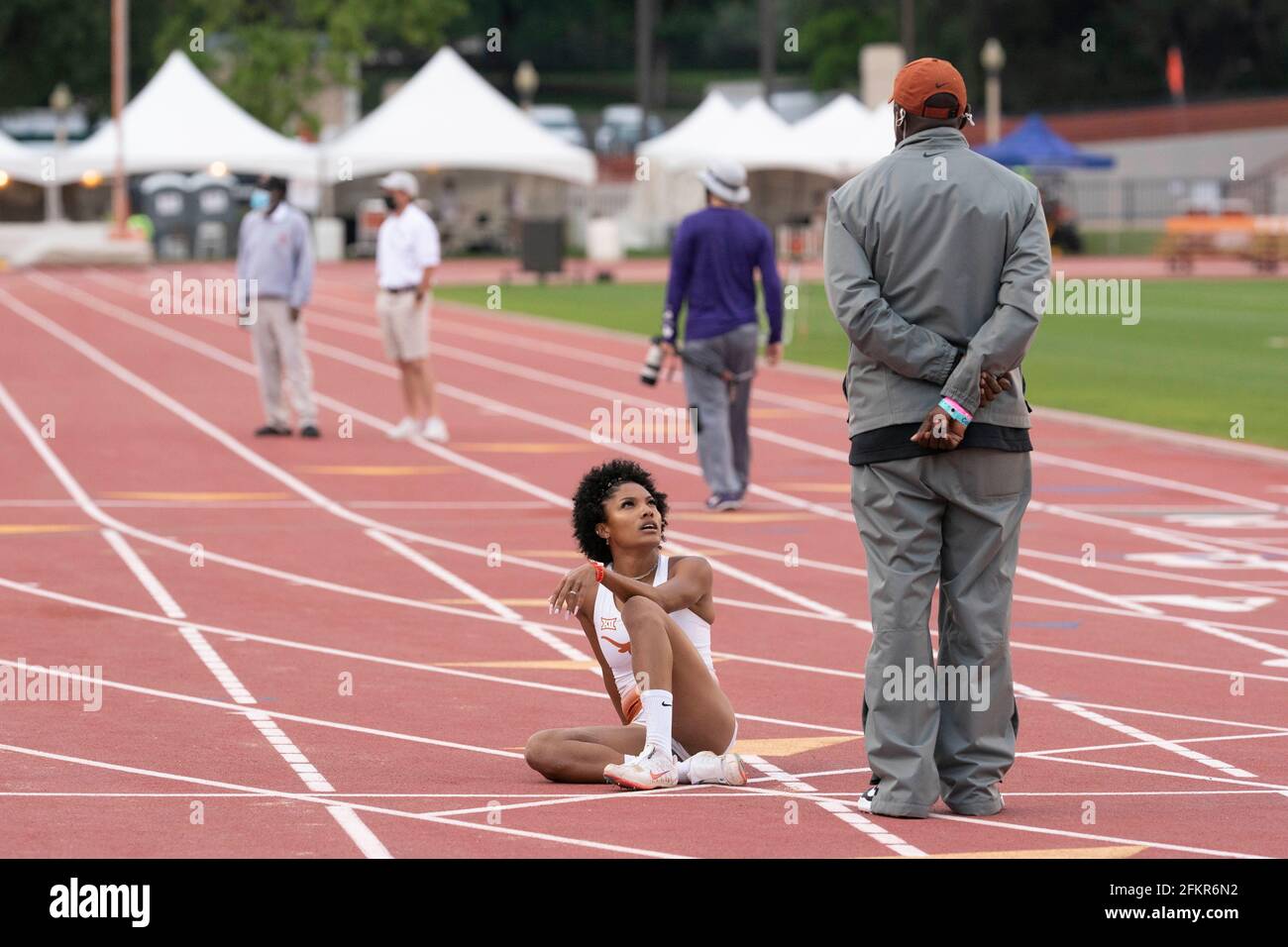 Austin, Texas, USA. 01st May, 2021. Texas women's long jump ace Tara Davis talks with coach Edrick Floreal after soaring to an easy victory at the Texas Invitational as she continues a quest for a spot on the 2021 U.S. Olympic team. Credit: Bob Daemmrich/Alamy Live News Credit: Bob Daemmrich/Alamy Live News Stock Photo