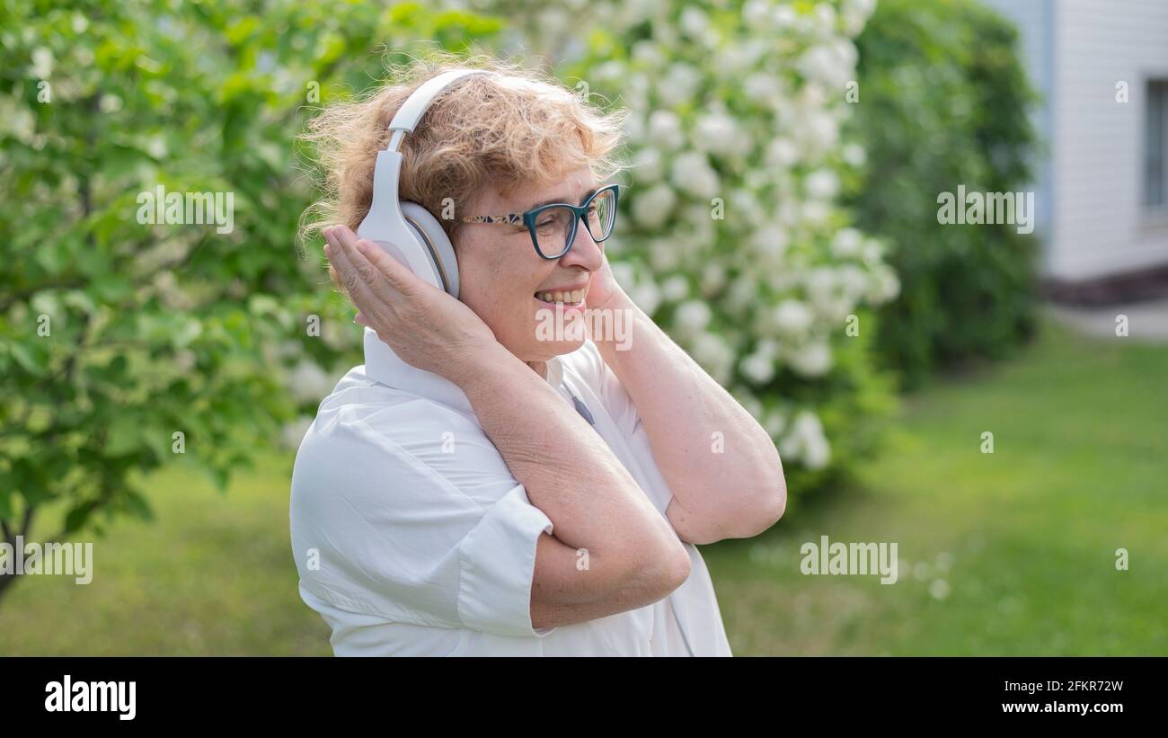 Happy smiling old woman walks hi-res stock photography and images - Alamy