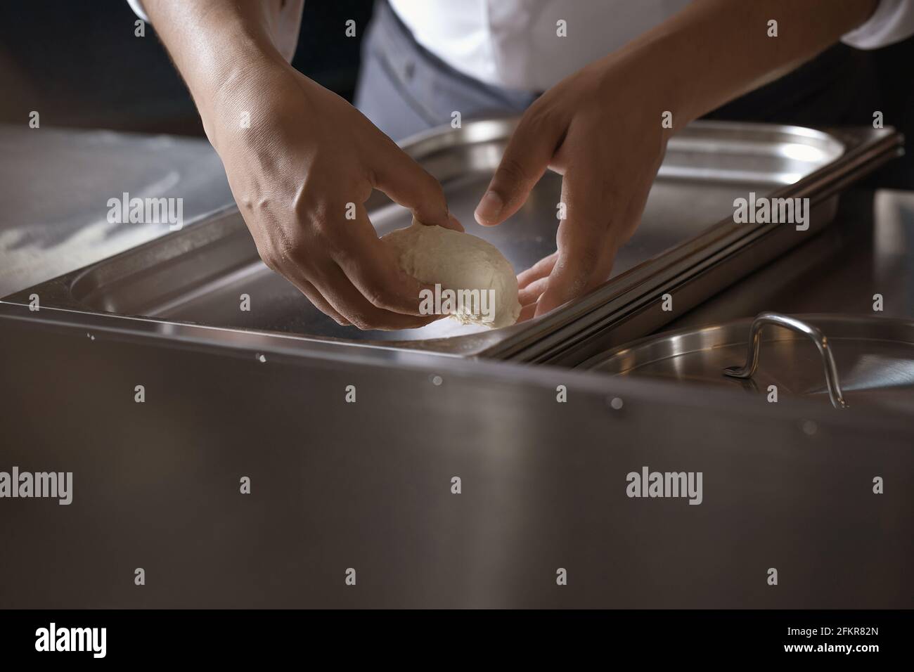 Making dough for bread by male hands in restaurant kitchen. Cooking ...