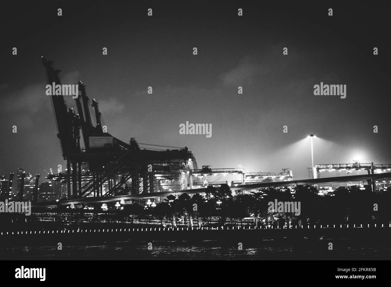 Cranes at night in the Pulau Brani Island, in Singapore. Stock Photo