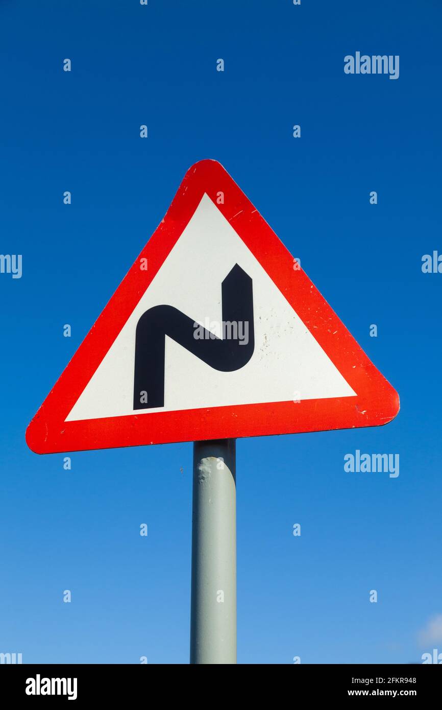 Double bend first to the right road sign Stock Photo