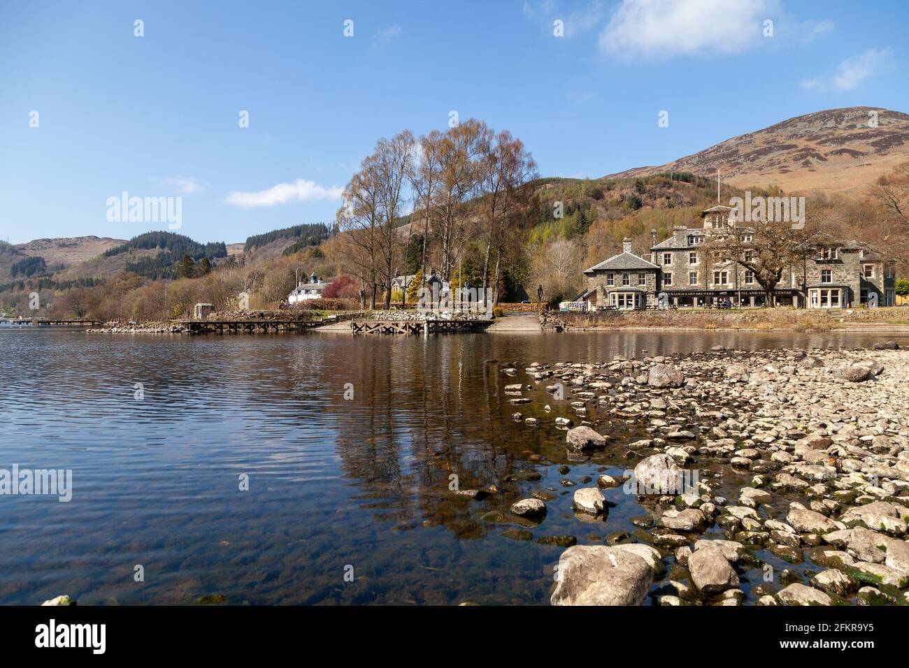 Looking towards the Hotel and Visitor Centre at St Fillans on Loch Earn, Scotland. Stock Photo