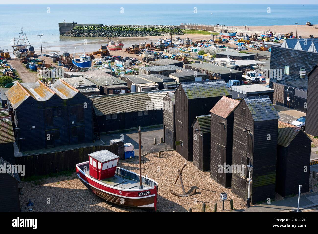 The Stade at Hastings Old Town, East Sussex, on the South Coast of England, with wooden net shops and fishing boats Stock Photo