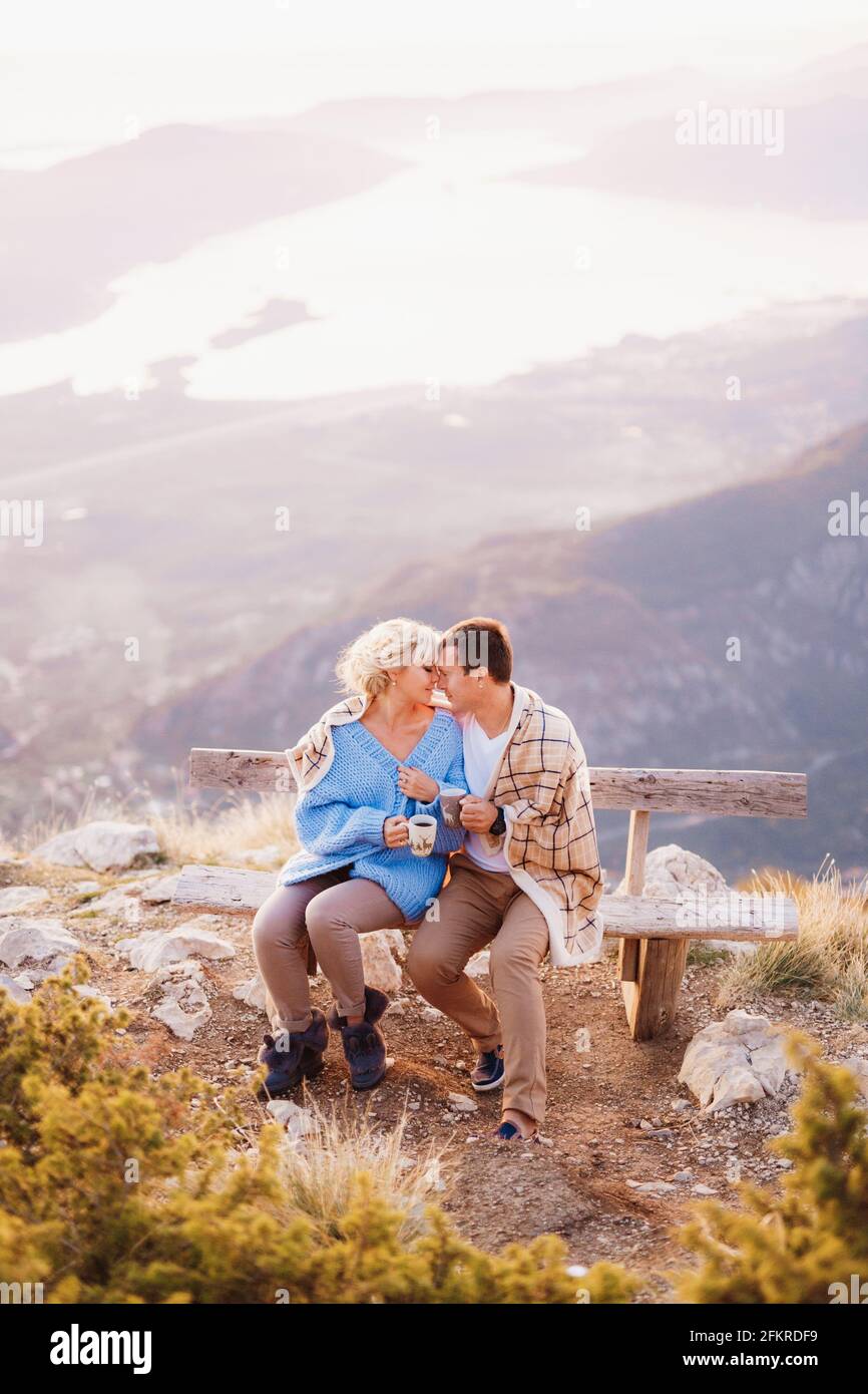 Couple sitting on top hill hi-res stock photography and images - Alamy