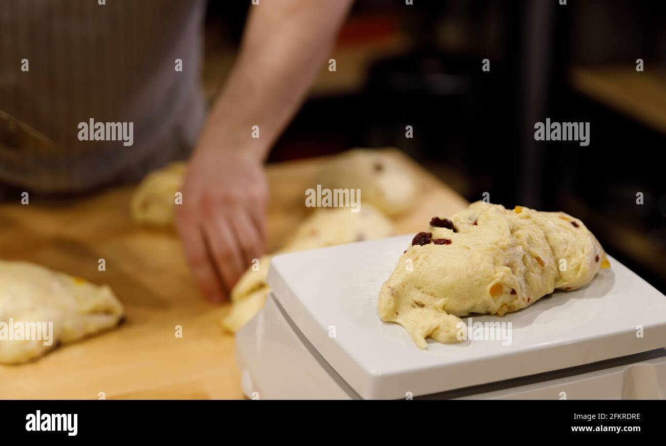 https://c8.alamy.com/comp/2FKRDRE/the-chef-hands-divide-the-sweet-dough-with-raisins-into-portions-on-a-table-2FKRDRE.jpg