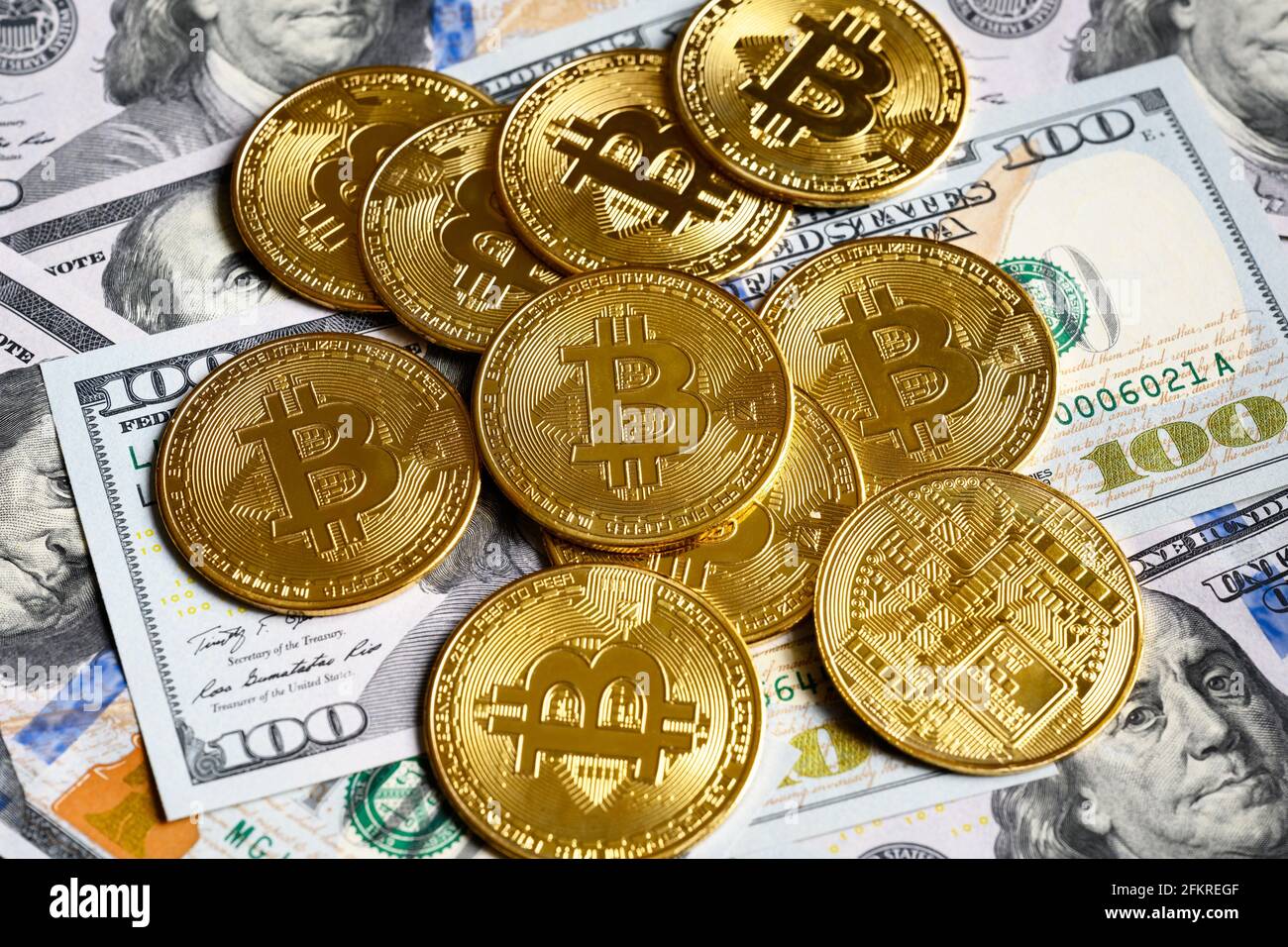 Bitcoin with dollar cash, virtual crypto currency bitcoin (btc) and banknotes. Gold bit coins on US dollar bills pile. Concept of bitcoin payment, dig Stock Photo