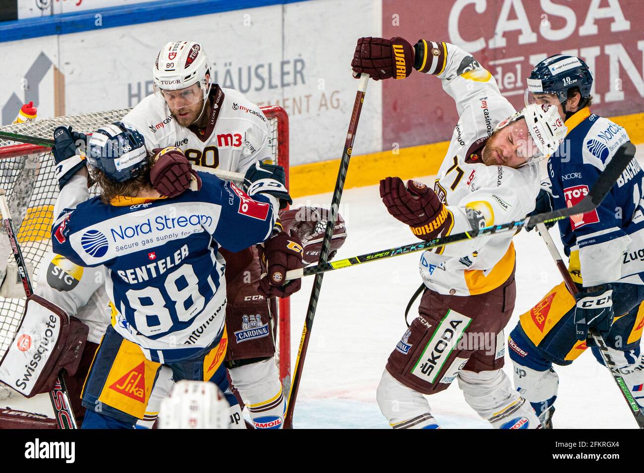 Sven Senteler # 88 (EV Zug) ensures traffic in front of the Geneva Gate at # 90 Simon Le Coultre (Geneva) and # 71 Tanner Richard (Geneva) during the National League Playoff Final ice hockey game 1 between EV Zug and Geneve-Servette HC on May 3rd, 2021 in the Bossard Arena in Zug. (Switzerland/Croatia OUT) Credit: SPP Sport Press Photo. /Alamy Live News Stock Photo
