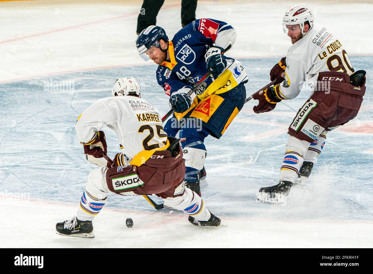 # 90 Simon Le Coultre (Geneva) and # 25 Roger Karrer (Geneva) stop Carl Klingberg # 48 (EV Zug) during the National League Playoff Final ice hockey game 1 between EV Zug and Geneve-Servette HC on May 3rd, 2021 in Bossard Arena in Zug. (Switzerland/Croatia OUT) Credit: SPP Sport Press Photo. /Alamy Live News Stock Photo