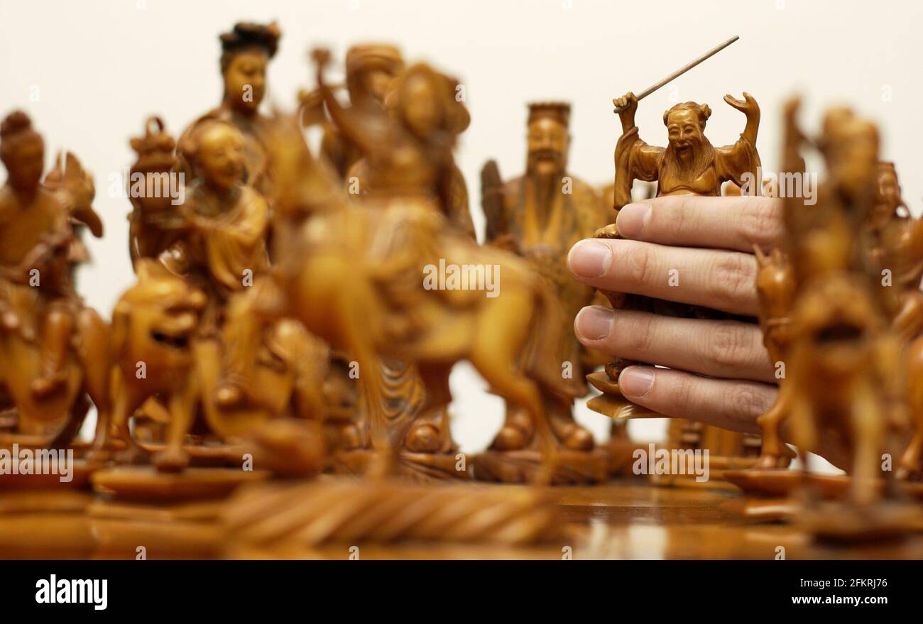 A fine chinese IVORY figural set of large size chess figures representing Chinese deities, one tea stained the other left natural, up for auction on Monday 4th November by Cooper Owen auctioneers. The set is est  3-5,000.28 October 2002 photo Andy Paradise Stock Photo