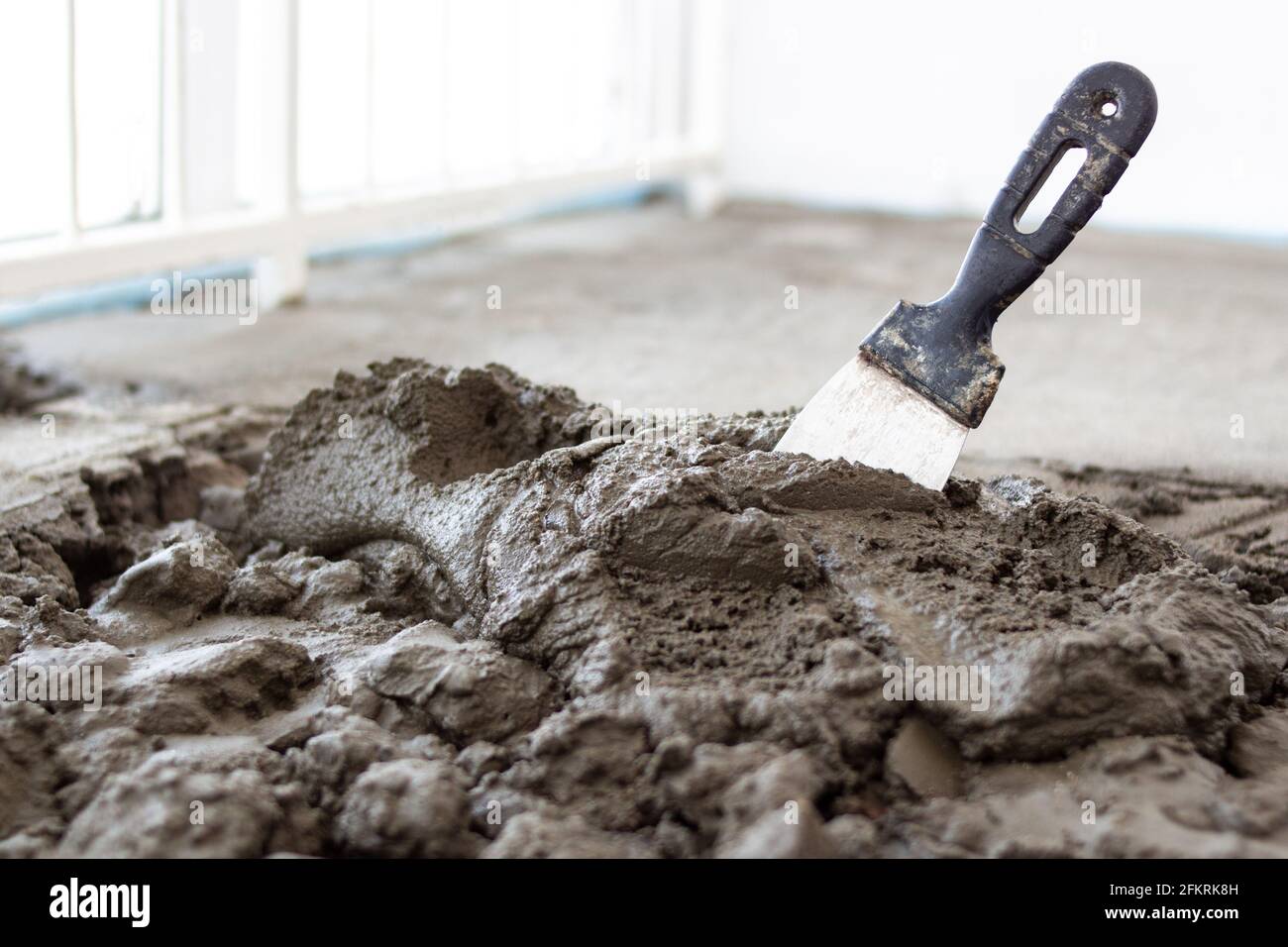 Red cement mix and trowel on the construction site Stock Photo - Alamy