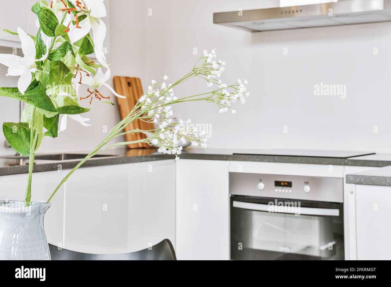Vase with flowers in kitchen Stock Photo Alamy