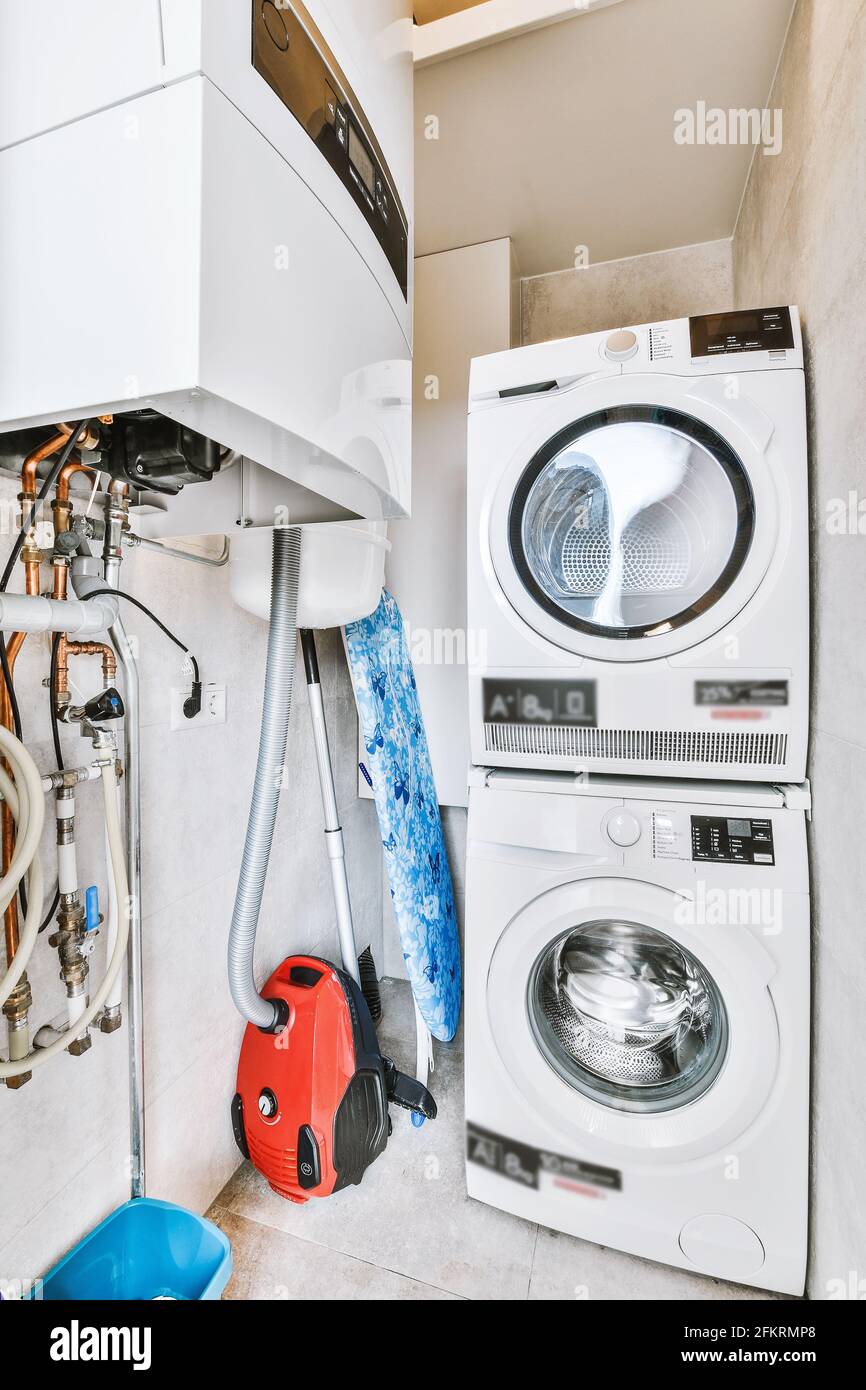 Washing and drying machines in closet Stock Photo