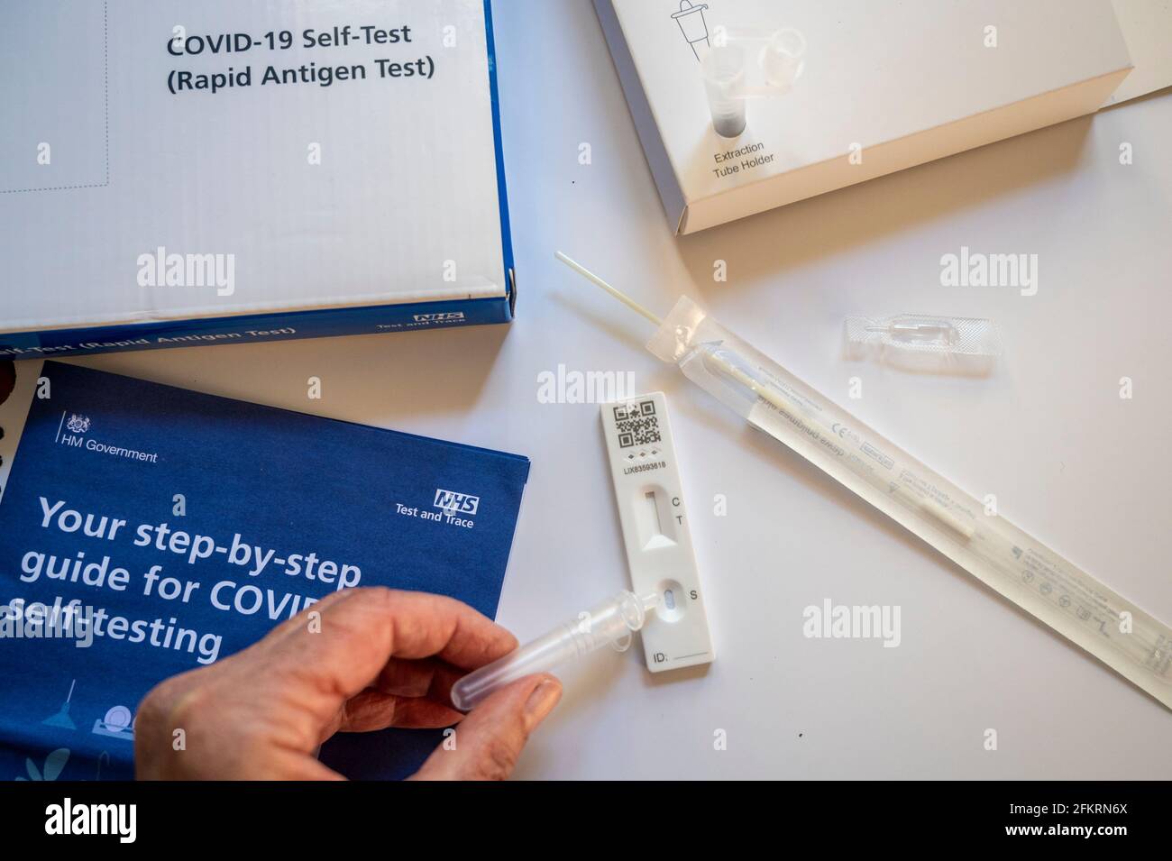 Contents of the NHS Covid19 rapid antigen selftest kit; a woman