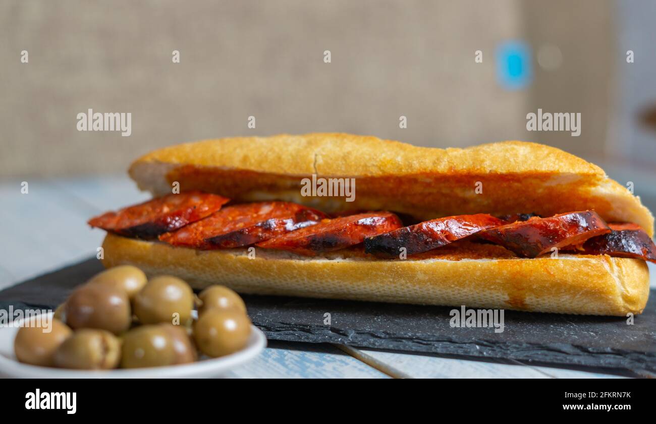 chorizo sandwich and olive tapa Stock Photo - Alamy