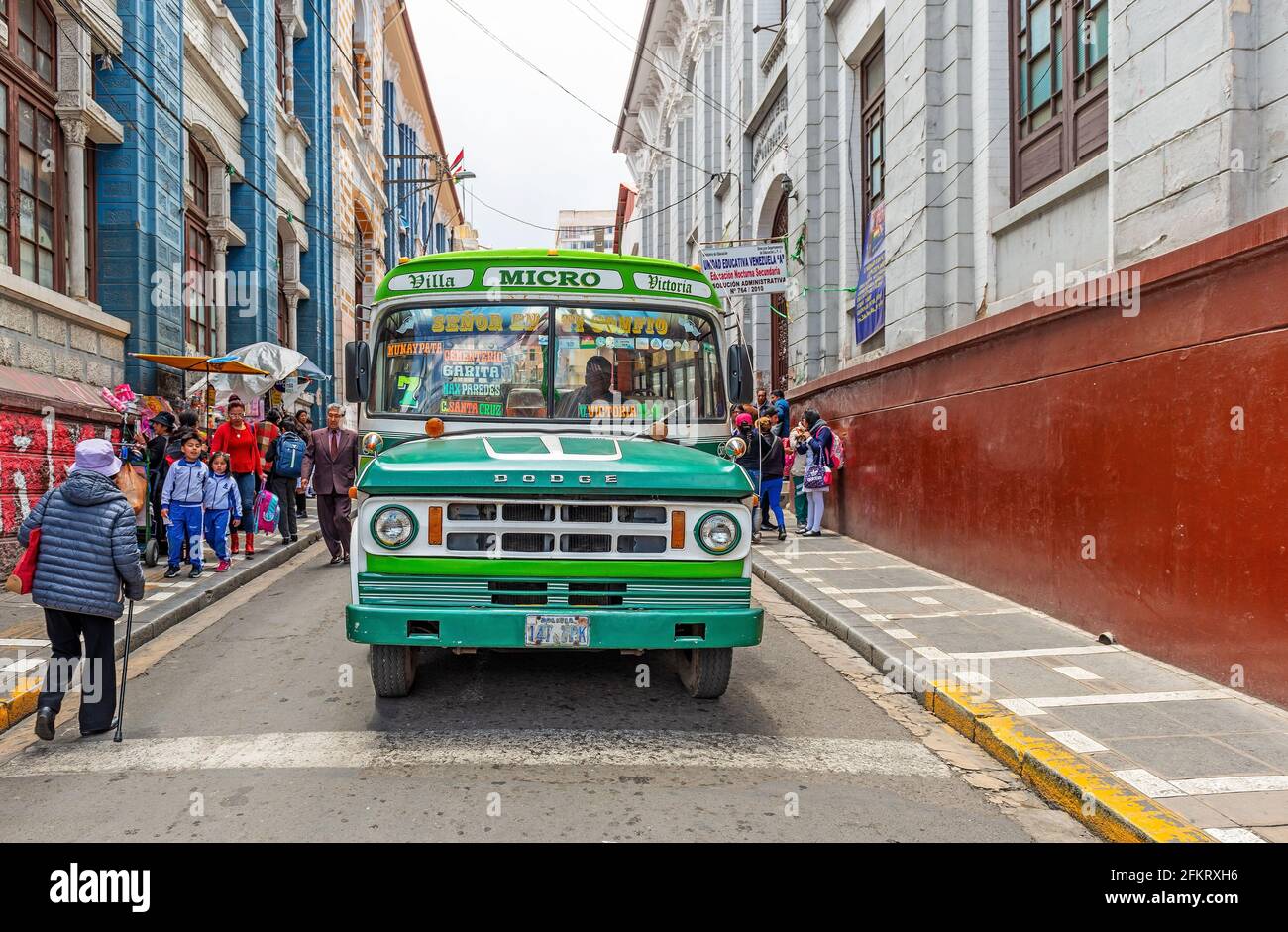 Colorful bus transport in the streets of La Paz with bolivian people, Bolivia. Stock Photo