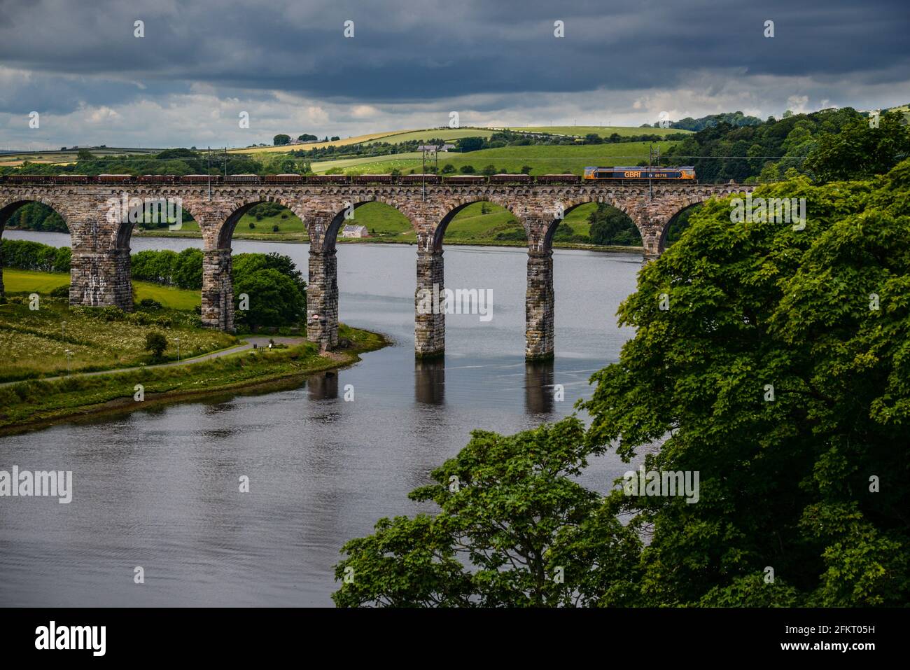 British Rail Class 66 operated by GB Raifreight (GBRf) heading north across the Royal Border Bridge at Berwick upon Tweed, Northumberland, England Stock Photo