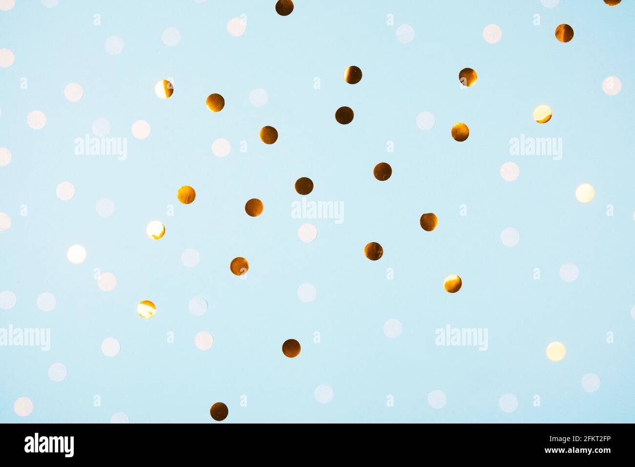 Festive light blue background with golden confetti Stock Photo