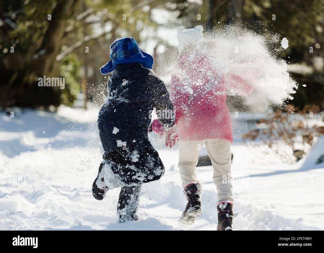 Two children running in snow Stock Photo