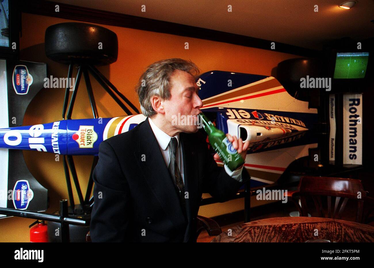Tony Banks Sports Minister MP Labour for Newham North East drinks a bottle of Rolling Rock Beer at the Sports Cafe in London before going to his new office at the Department of National Heritage Stock Photo