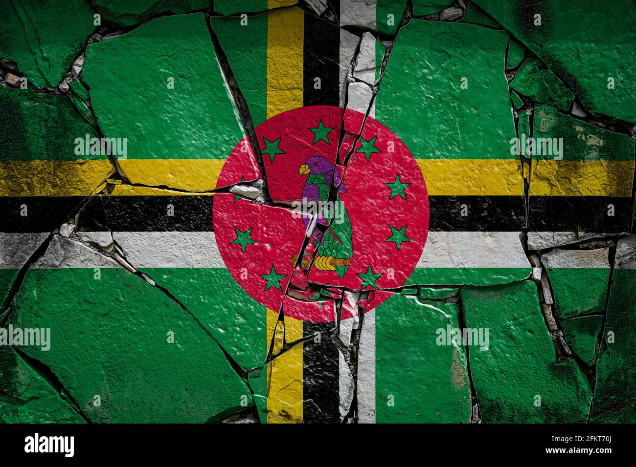 National flag of Dominica depicting in paint colors on an old stone ...