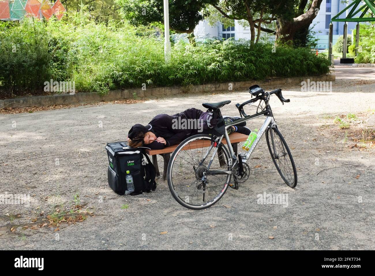 An Uber Eats courier taking a break in between deliveries in 