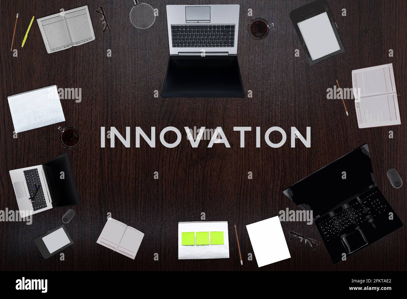 Innovation concept. Top layout of drawings of laptops, notepads, coffee, different business stuff on black background. Stock Photo