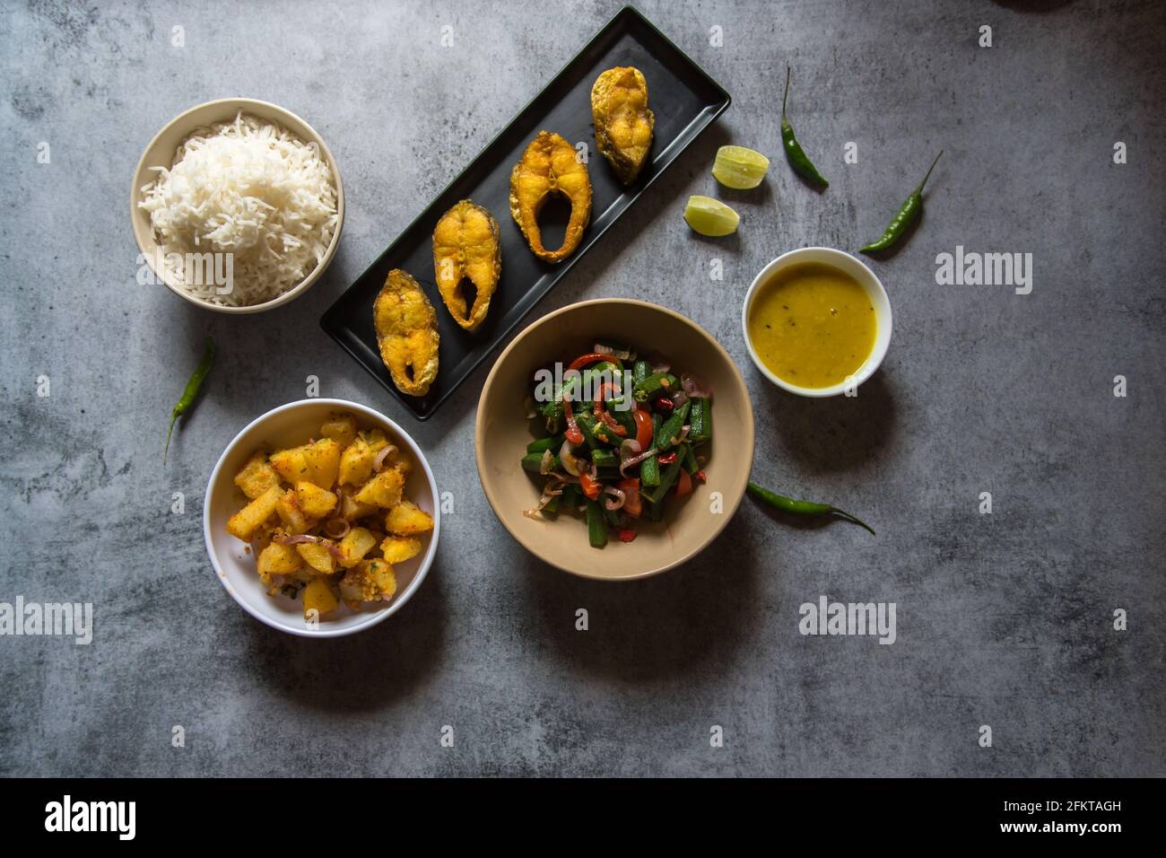 Indian lunch food ingredients rice fish vegetables and pulses with use
