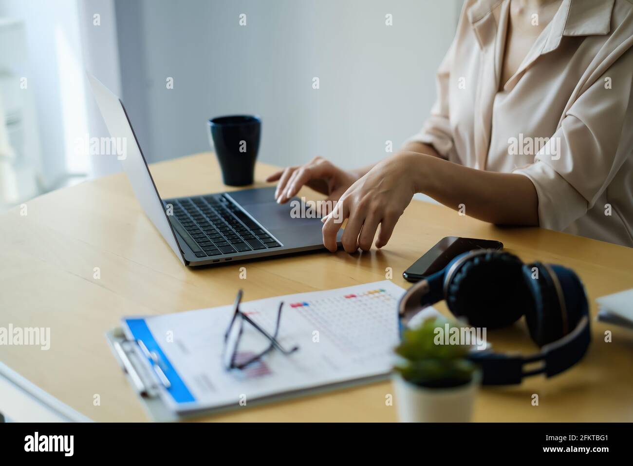 Close up casual asian business woman sitting and reading morning news via laptop, relaxed working on laptop. Stock Photo