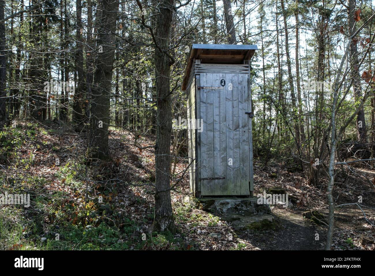 The rural wooden dry toilet standing in the wood by the cottages area. Stock Photo