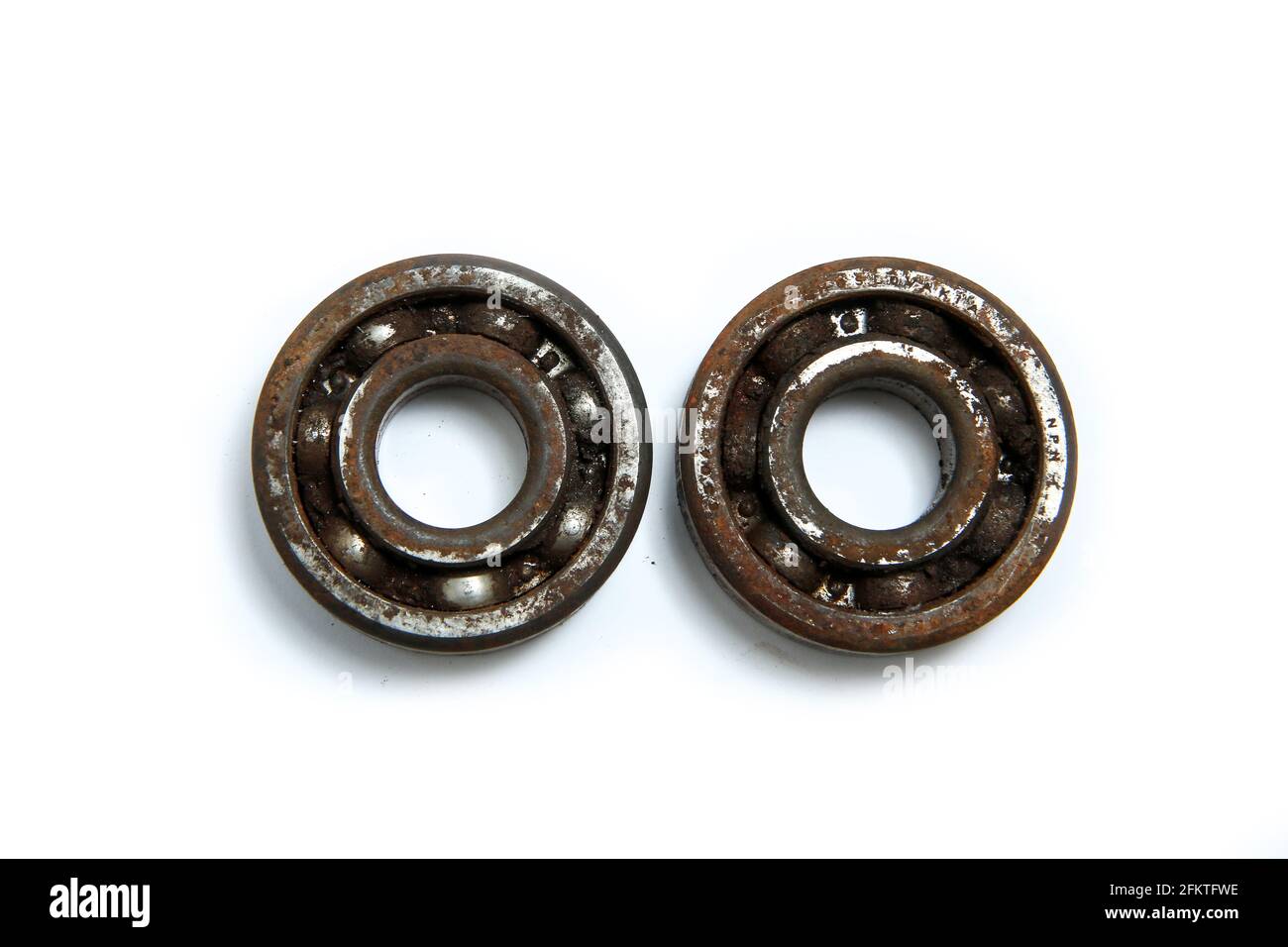 The rusty old bearings isolated in a white background. Jammed and unusable. Stock Photo