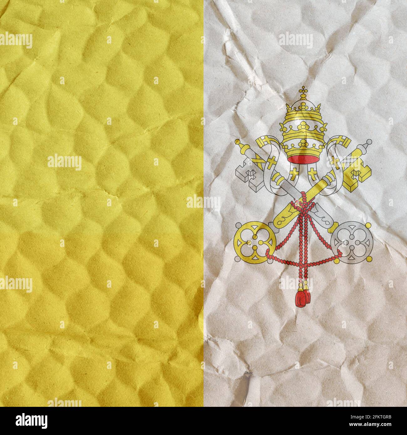 Yellow and white Vatican flag on an uneven textured surface. The concept of freedom, independence, supremacy of the church Stock Photo