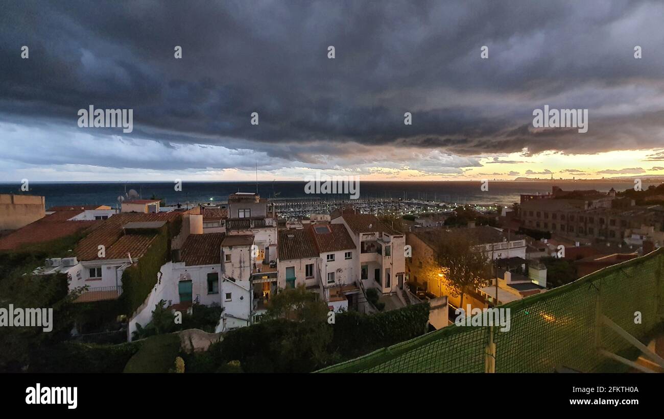 Stormy clouds at sunset, dramatic sky, coastal landscape, weather scenery El Masnou, Barcelona, Spain Stock Photo