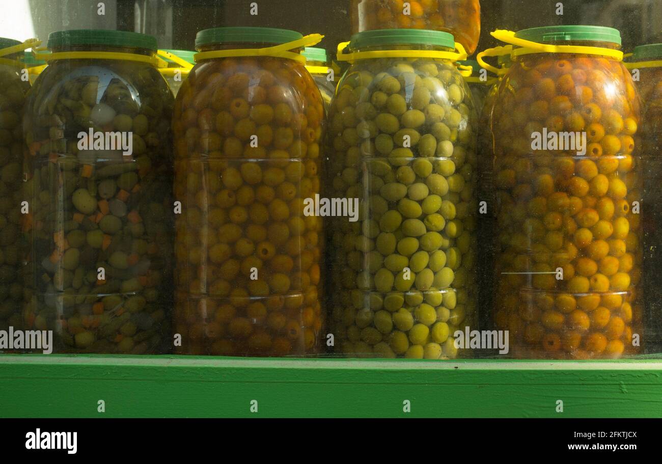 Huge plastic jugs of spanish pickles olives. Some varieties used in in
