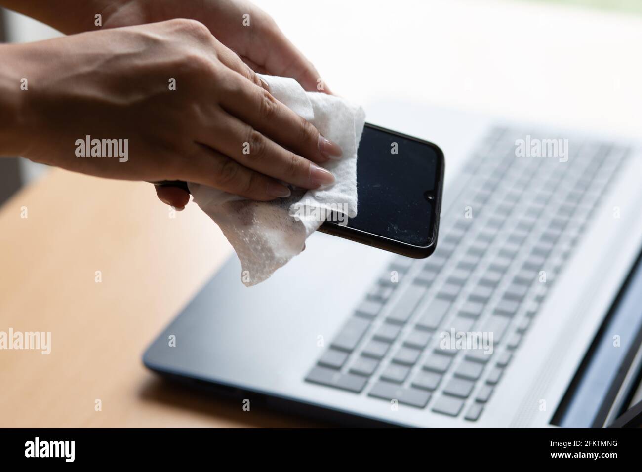 Work from home safe, cleaning and disinfecting smartphone and laptop