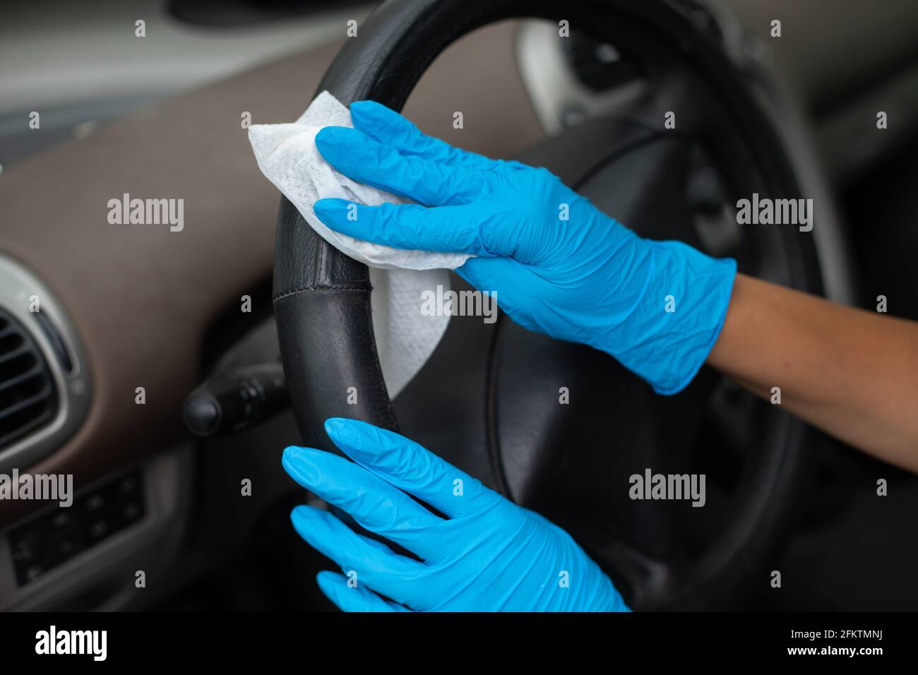 Cleaning car enterier wit antibacterial wet wipes. Stock Photo
