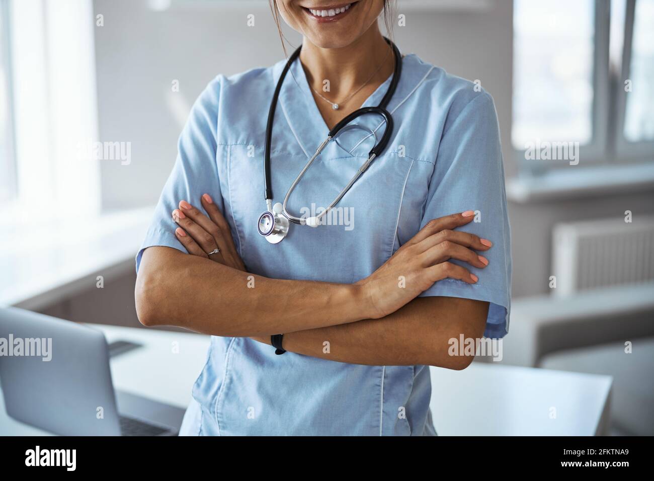 Joyful female doctor standing hi-res stock photography and images - Alamy